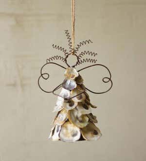 a christmas tree ornament hanging from a rope with shells on it's side