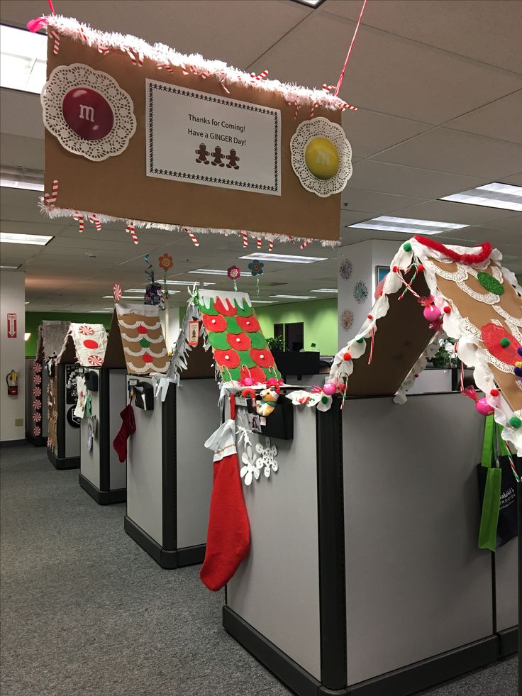 an office cubicle decorated for christmas with stockings and stocking hanging from the ceiling