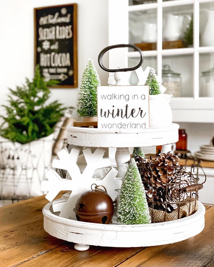 a wooden table topped with christmas decorations and trees on top of it's tray