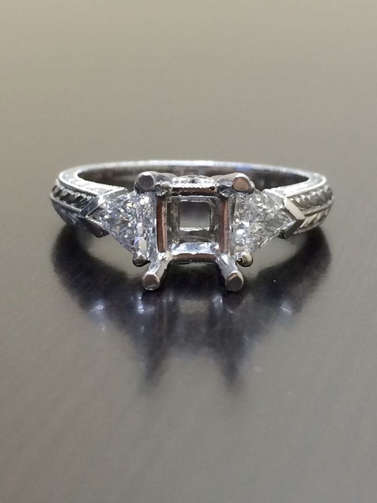 a three stone ring with two diamonds on it