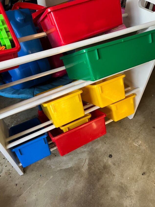 several bins are stacked on top of each other in a storage unit for toys