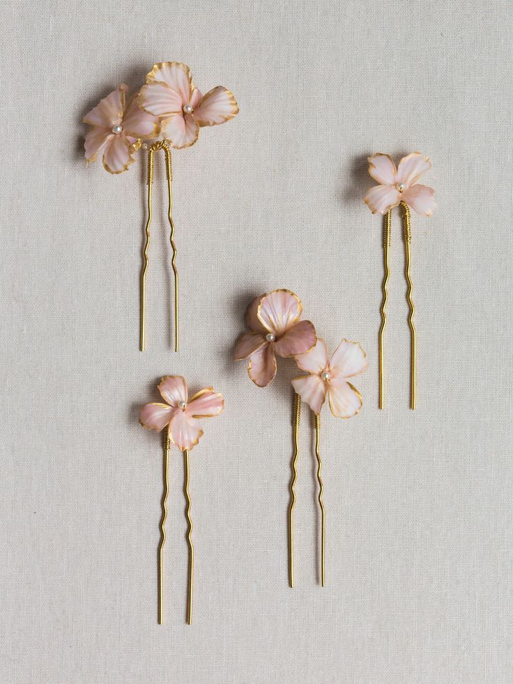 The Florence Hair Pin Set is a dash of sweetness for your tresses. Varying shapes and sizes of ruffled flowers with layers of blush and rose colors are applied by hand accented with golden edges and Swarovski pearl centers for the ultimate finishing touch. Wear using one, two, or all of the pins. Versatile styling ensures these will become a wardrobe staple whenever you want a little something extra in your hair. All flowers are created by hand, sculpted in our studio. Shipping and Production Garden Outfit, Printable Self Care, Rose Colors, Self Care Checklist, Streamer Dr, Flower Hair Pins, Floral Hair Pins, Gardening Outfit, Flower Hair Accessories