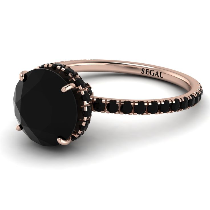 a black diamond engagement ring set in rose gold with an oval cut on the side