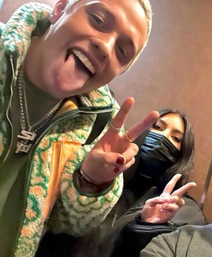 two people making the peace sign with their hands