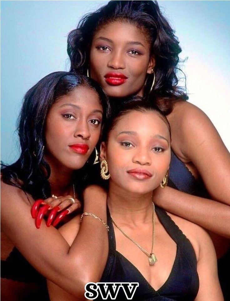 three women are posing for a photo together, one is wearing red lipstick and the other has black hair