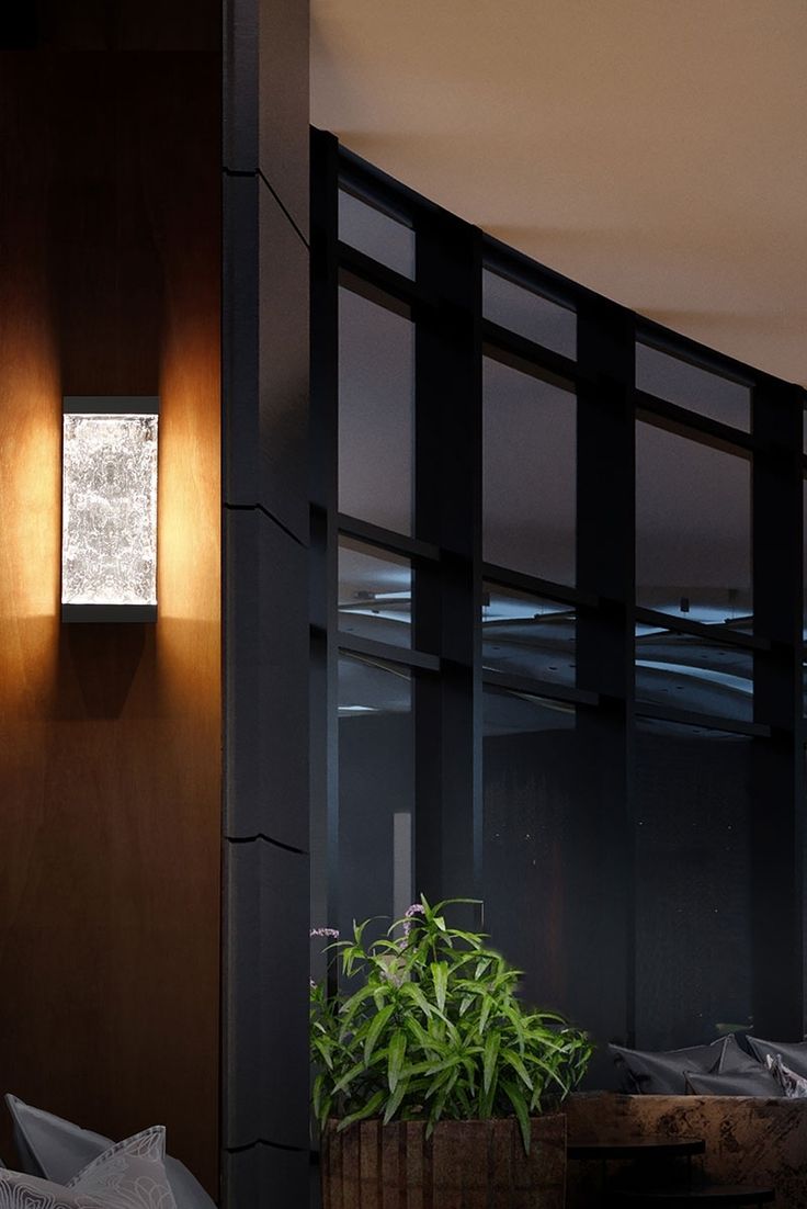 a potted plant sitting on top of a wooden table next to a window covered in blinds