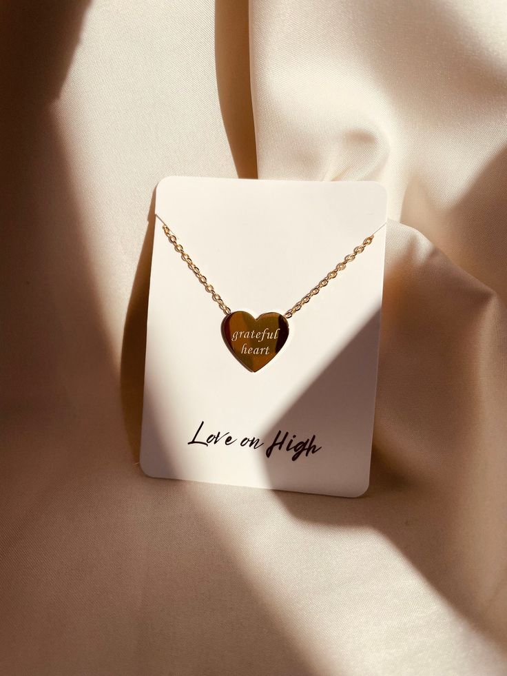 Our Grateful Heart Necklace was meticulously crafted to keep cherished sentiments near and dear, offering a daily reminder of gratitude and faith. Designed to be more than just an accessory, this necklace serves as a tangible connection to what truly matters. Embrace the delicate beauty of this necklace, featuring an elegant charm engraved on one side. Measuring 12mm by 11mm, the charm is suspended from a dainty yet durable chain, providing a subtle accent to any ensemble. Crafted with precision Tarnish Resistant Necklaces For Mother's Day Anniversary Gift, Tarnish Resistant Necklaces For Anniversary And Mother's Day, Tarnish Resistant Necklace For Anniversary, Mother's Day, Tarnish Resistant Jewelry For Valentine's Day Gift, Valentine's Day Gift Tarnish Resistant Jewelry, Valentine’s Day Gift Tarnish-resistant Jewelry, Elegant Heart Pendant Jewelry For Best Friend, Double Heart Tarnish Resistant Necklace For Mother's Day, Heart-shaped Gold Necklace For Best Friend