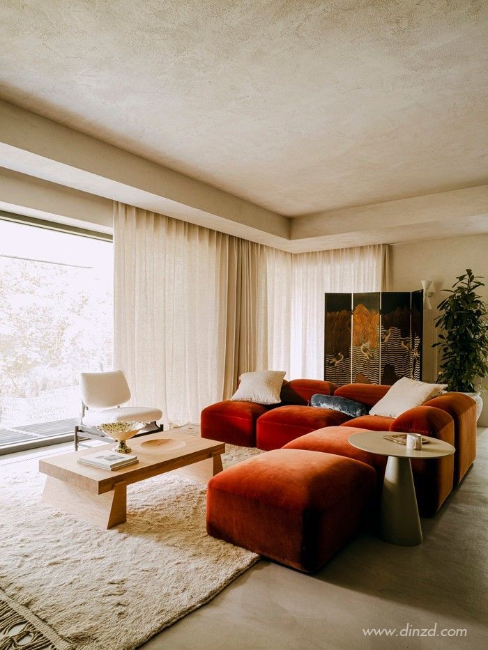 a living room with two couches and a coffee table in front of a large window