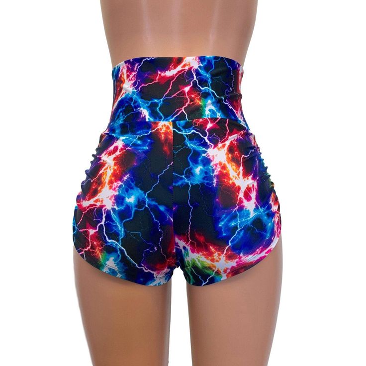 High-waisted booty shorts made in sparkle cosmic thunder UV Glow print stretchy performance spandex with ruching on the sides and lace-up detail in front. Made to flatter your figure and move with you. These booty shorts shine in different colors in the light - for a true holographic effect. The standard inseam is 2.5" - but can be customized. Trendy High Waist Swimwear With Built-in Shorts, Trendy High-waist Swimwear With Built-in Shorts, High Waist Shorts For Cheerleading In Summer, Trendy Stretch Bottoms For Cheerleading, Trendy Fitted Shorts For Swimming, Trendy Fitted High Waist Athletic Shorts, Fitted Multicolor Gym Shorts, Stretch Rave Shorts, Fitted Rave Shorts