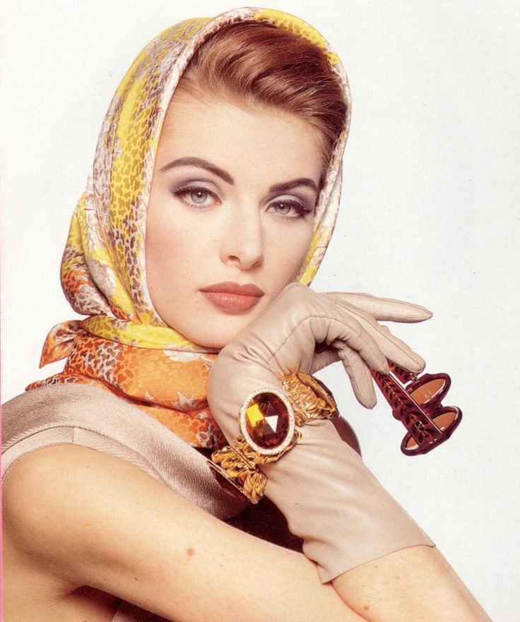 black and white photograph of a woman wearing a headscarf holding an old fashioned watch