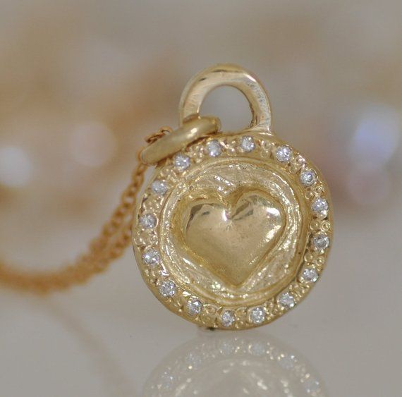 Gold and Diamonds Necklace, a unique handmade piece, a perfect gift idea for the one you love. 14k solid gold disc pendant, perfect love gift for the one you love, a perfect gold gift for wife or for daughter. Heart round pendant 1.2 c"m * 1.1 m"m 14k solid gold with 16 small white Diamonds and 14k gold chain.A beautiful heart sticks out on the center of a naive gentle pendant and a circle around. 16 Diamonds are set around in an antique style I can set small gemstones or diamonds on this circle Handmade Double Heart Jewelry For Anniversary, Handmade Heart Pendant Necklace For Anniversary, Yellow Heart-shaped Jewelry For Valentine's Day, One Of A Kind Heart Jewelry For Anniversary, Yellow Heart Pendant Jewelry For Anniversary, Yellow Necklace With Heart Charm For Gift, Handmade Open Heart Jewelry For Anniversary, Handmade Yellow Gold Jewelry For Valentine's Day, Yellow Jewelry With Heart Charm For Anniversary