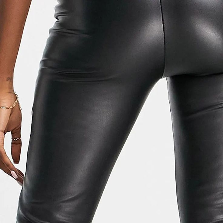 Discover the essence of sleek and modern style with our Sleek High-Waist Stretch Pencil Trousers. These trousers are a perfect blend of casual elegance and comfortable wear, suitable for all seasons. The high waist design not only adds a touch of sophistication but also provides a flattering fit for various body types. Crafted with a medium stretch fabric, these trousers ensure both comfort and a figure-hugging silhouette. The PU faux leather material, combined with spandex, offers a luxurious feel and a flexible fit, making these trousers ideal for day-long wear. Featuring a solid pattern and a classic pencil pant style, these trousers are a versatile addition to your wardrobe. Whether it's a day at the office or a casual evening out, these trousers adapt effortlessly to any setting. The Sleek High Waist Leggings, Modern Black High-waisted Leather Pants, Fitted Black Modern Bottoms, Fitted Modern Black Bottoms, Modern Fitted Black Bottoms, Black Stretch Modern Leggings, Chic Elastane Leggings For Business Casual, Sleek Leather Pants For Going Out, Elastane Leather Pants For Workwear In Fall