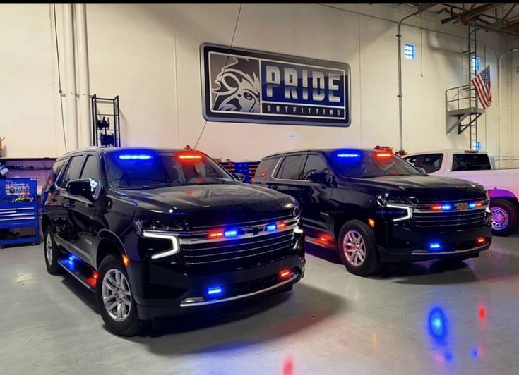 two police cars are parked in a garage