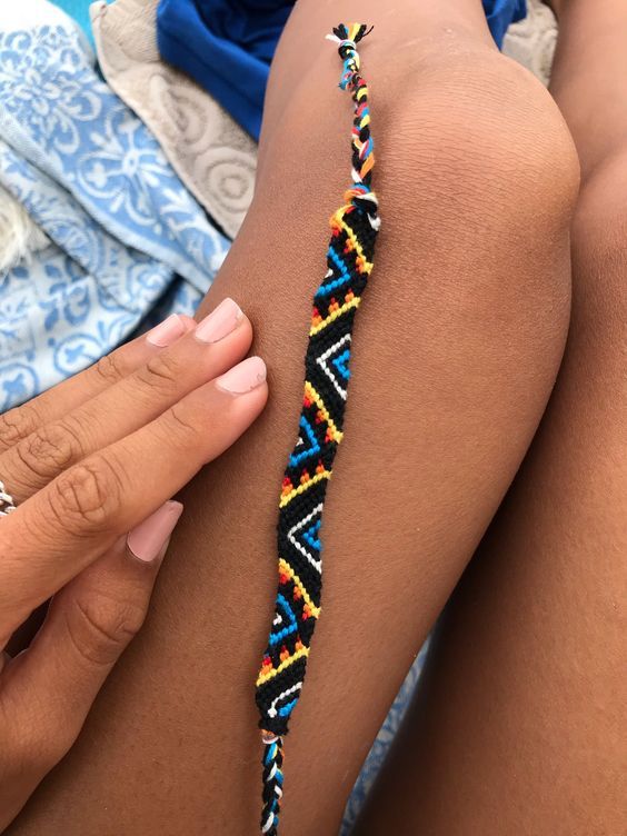 a woman's arm with a colorful bracelet on it