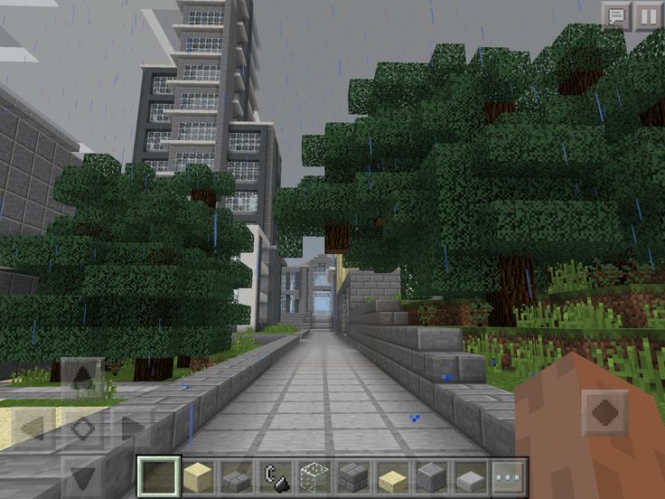 an image of a city in minecraft with trees and buildings on either side of the street