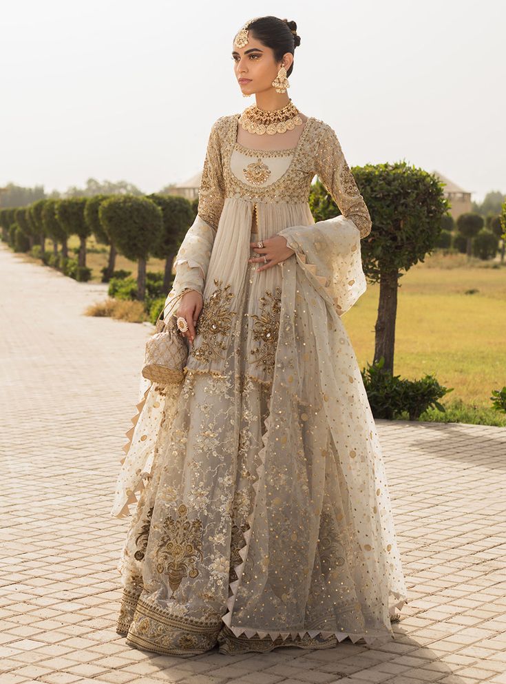 NOOREH’ is a perfect bridal ensemble for an intimate Nikkah ceremony. Look beautiful in our crushed front open short peplum accentuated with embellished floral motifs and intricately embellished neckline and sleeves. This gorgeous Sharara is heavily embroidered with floral pattern all over decorated with floral vases a Zainab Chottani, Desi Dress, Walima Dress, Desi Wedding Dresses, Nikkah Dress, Asian Bridal Dresses, Asian Wedding Dress, Bridal Dresses Pakistan, Pakistani Wedding Outfits