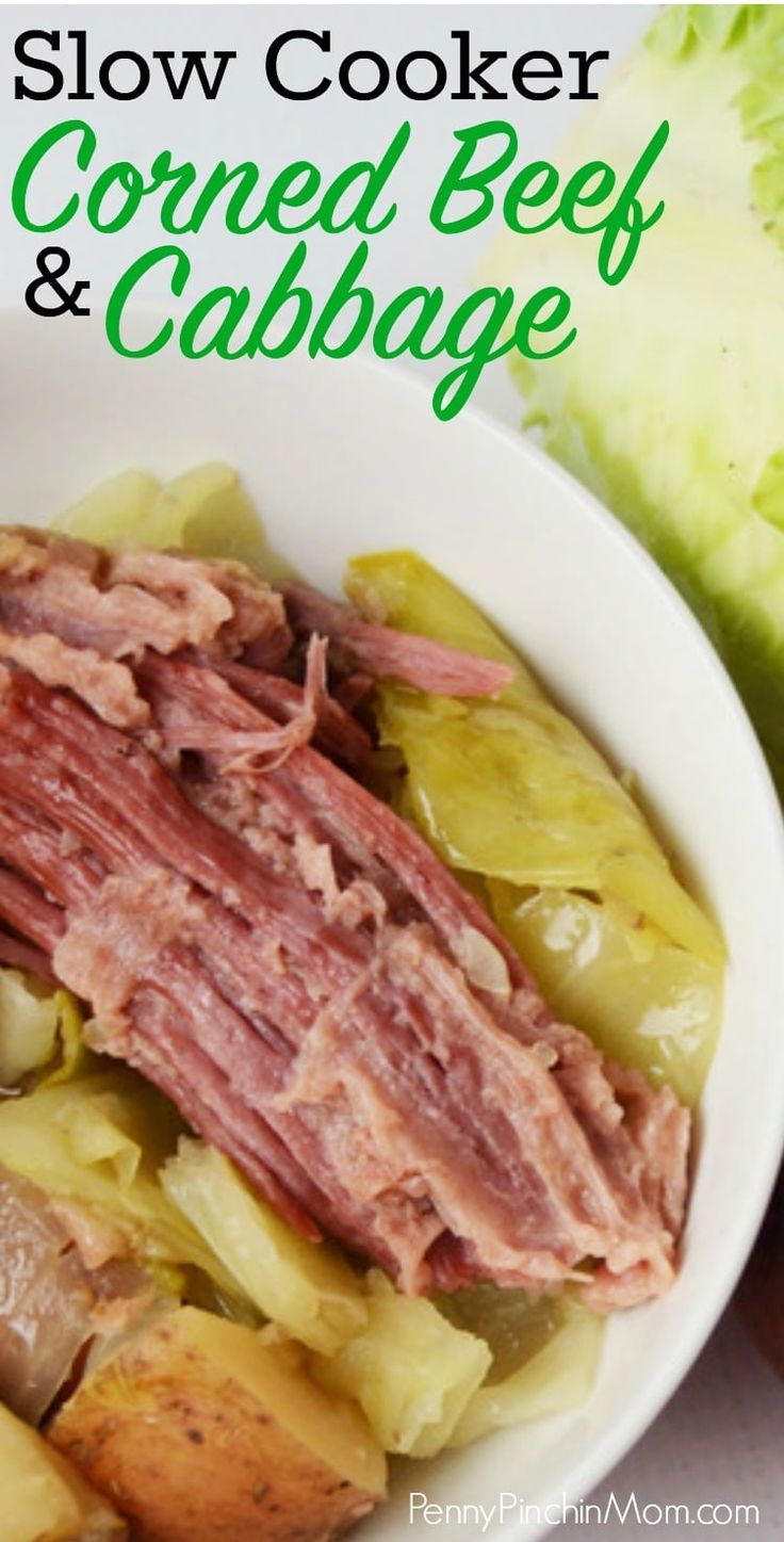 slow cooker corned beef and cabbage in a white bowl next to lettuce