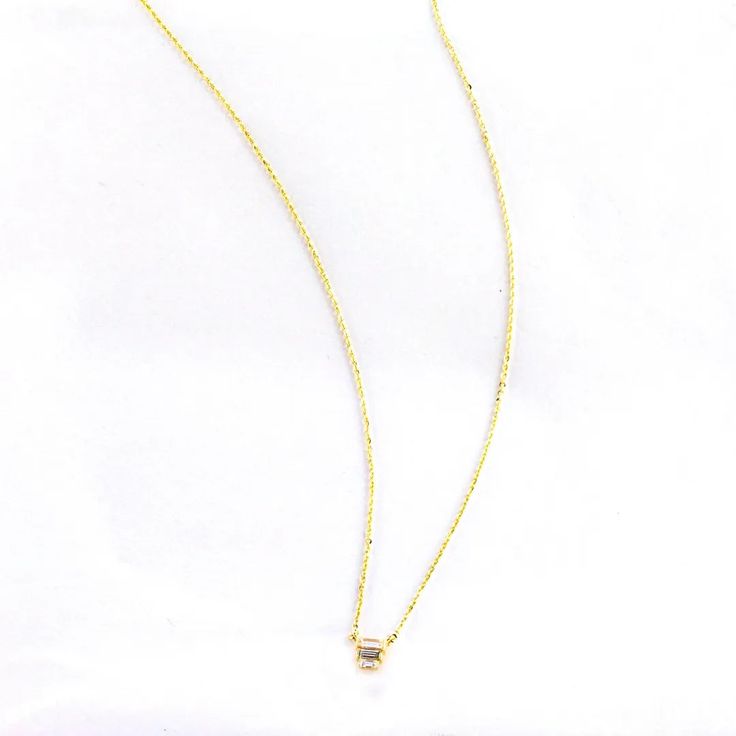 This beautiful trio baguette necklace features a classic design made of three glittering baguettes surrounded by a shiny gold plated chain. It's the perfect accessory for any occasion, sure to add a sparkle to your look. Gold Baguette Diamond Jewelry For Party, Elegant Gold Baguette Cut Necklace, Elegant Gold Necklace With Baguette Shape, Elegant Gold Baguette Necklace, Elegant Gold Necklace With Baguette Diamonds, Elegant Gold Necklaces With Baguette Diamonds, Gold Baguette Diamond Necklaces For Gift, Gold Necklaces With Baguette Diamonds As Gift, Gold Baguette Cut Diamond Necklace Gift