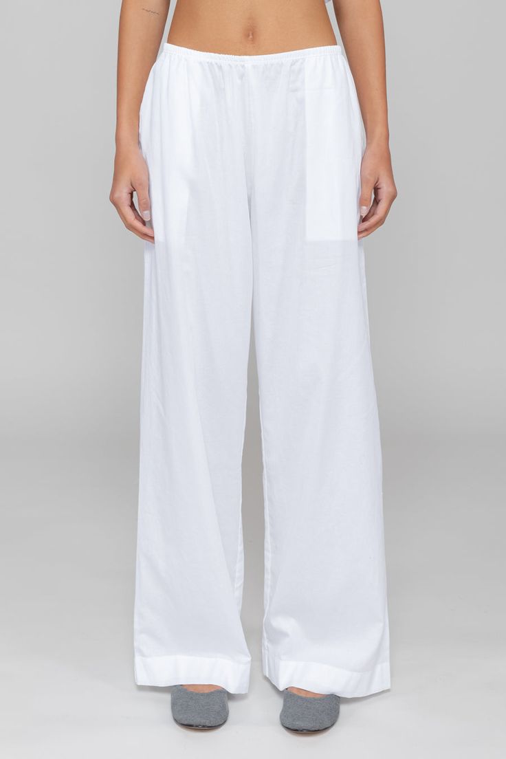 Breeze into summer. Our bestselling Yoko Pocket Pant returns: Cut in 100%, crisp cotton lawn, this wear-anywhere pant features a comfortable elasticized waistband, side seam pockets, the perfect relaxed fit. Loosely Fitted Pull-on Pants, Daywear Bottoms With Pockets And Straight Hem, Relaxed White Bottoms With Pockets, Cotton Wide-leg Pants With Elastic Side Panels, Versatile Pants With Side Pockets And Straight Hem, White Bottoms With Elastic Waistband For Work, White Elastic Waistband Bottoms For Work, White Straight Leg Daywear Pants, White Pants With Pockets For Daywear