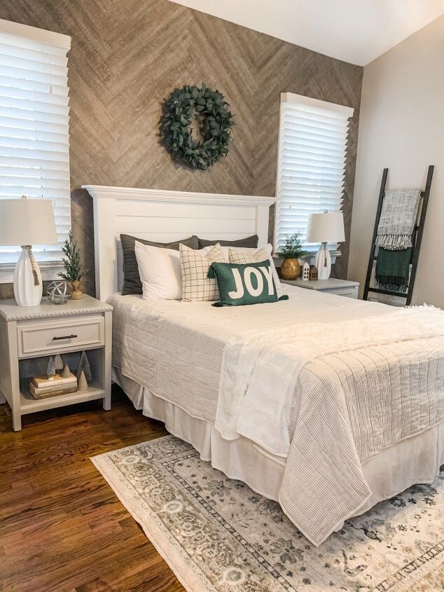 a white bed sitting in a bedroom on top of a wooden floor