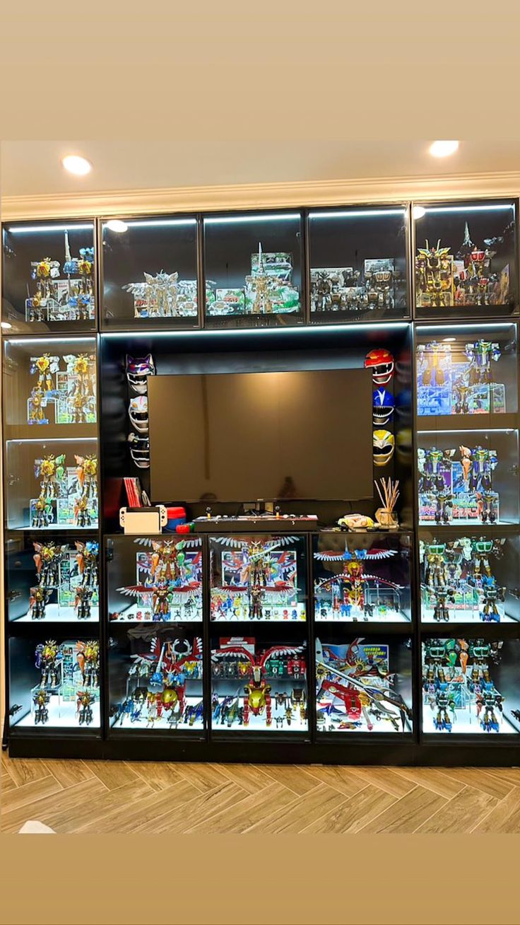 a display case filled with lots of toy figurines and toys in glass cases