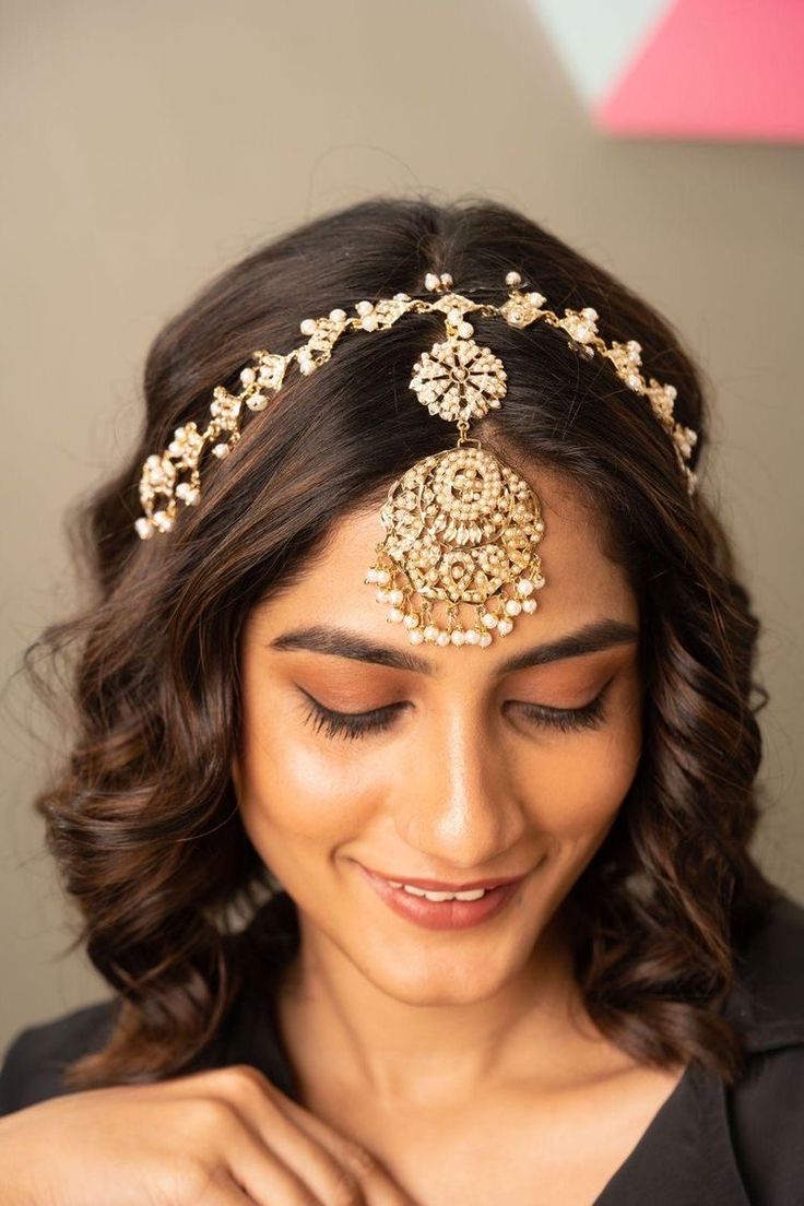 a woman wearing a gold head piece