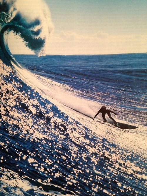 a man riding a wave on top of a surfboard