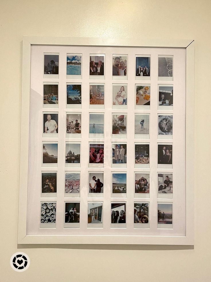 a white frame with many pictures hanging on the wall