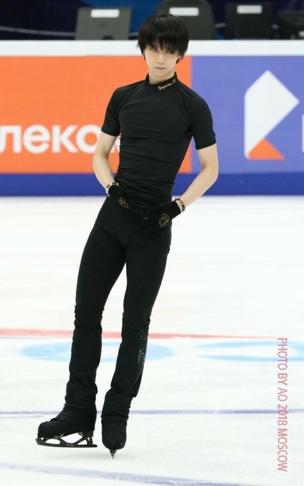 a male figure skating on an ice rink