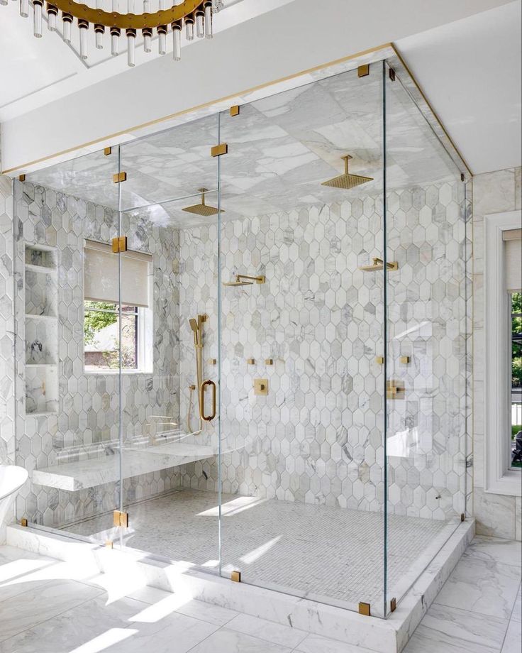 an elegant bathroom with marble and gold accents