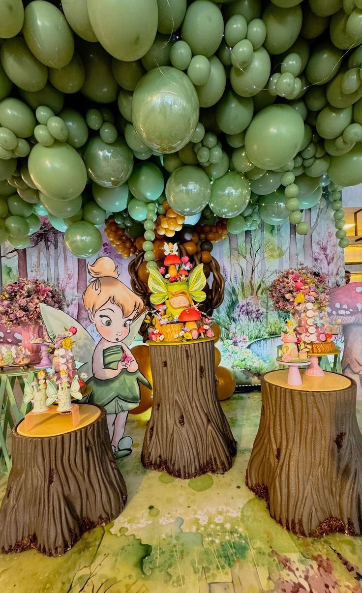 balloons are hanging from the ceiling in front of an image of tinkerbells