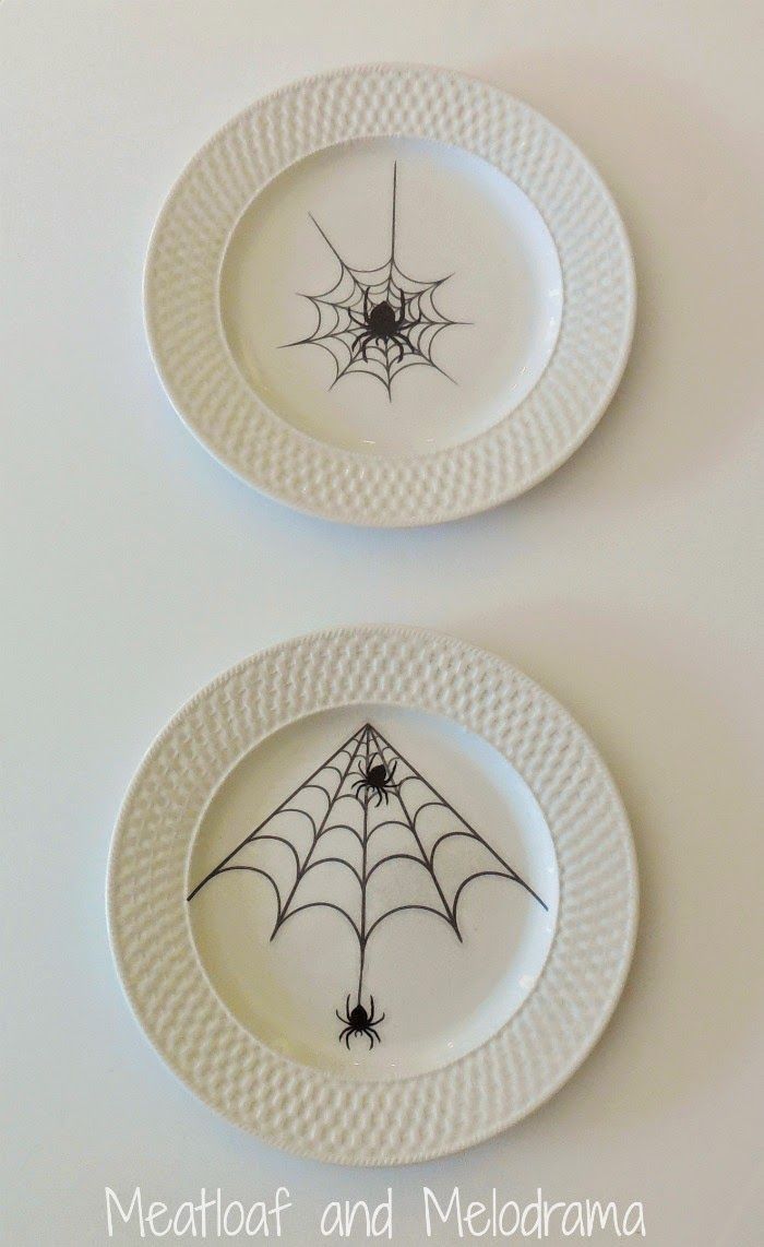 two plates with spider web designs on them