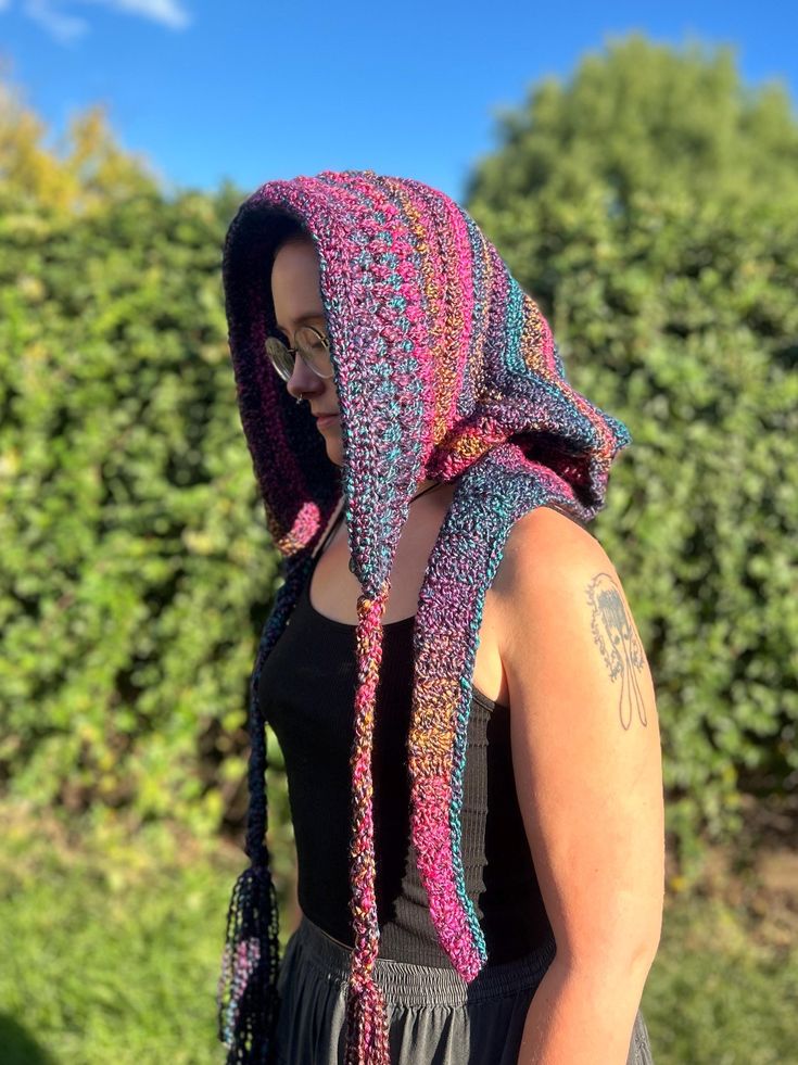 This is a handmade crochet hood! It's made with Loops and Threads Twisted Texture yarn. Also, it has wooden beads on the tassels of the hood. A fun comfy hood to keep you warm in the Fall and Winter! ✨ Hood pattern by: sylviedameycrochet Crocheted Hood, Bohemian Crochet Hat For Beach In Fall, Bohemian Crochet Beach Hat For Fall, Handmade Bohemian Crochet Hat For Fall, Bohemian Crochet Hat For Fall, Bohemian Crochet Hat In Yarn For Winter, Bohemian Crochet Cotton Hat, Bohemian Yarn Bonnet For Winter, Bohemian Crochet Yarn Bonnet