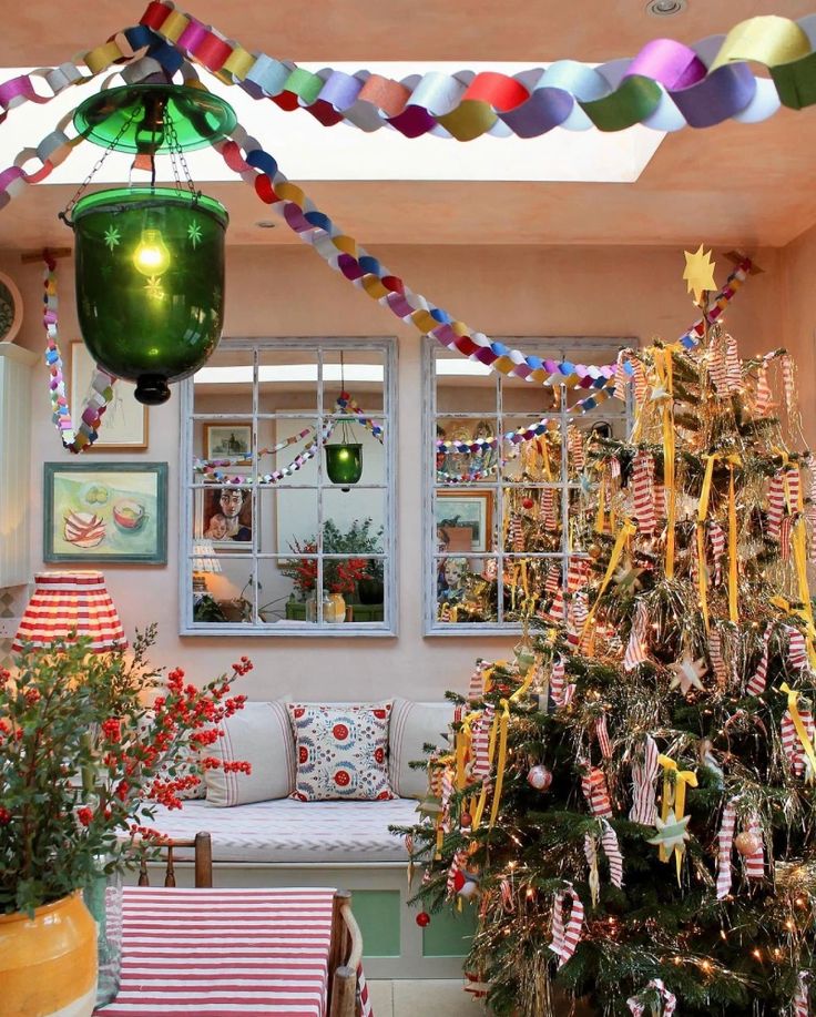 a decorated christmas tree sitting in the middle of a living room next to a window