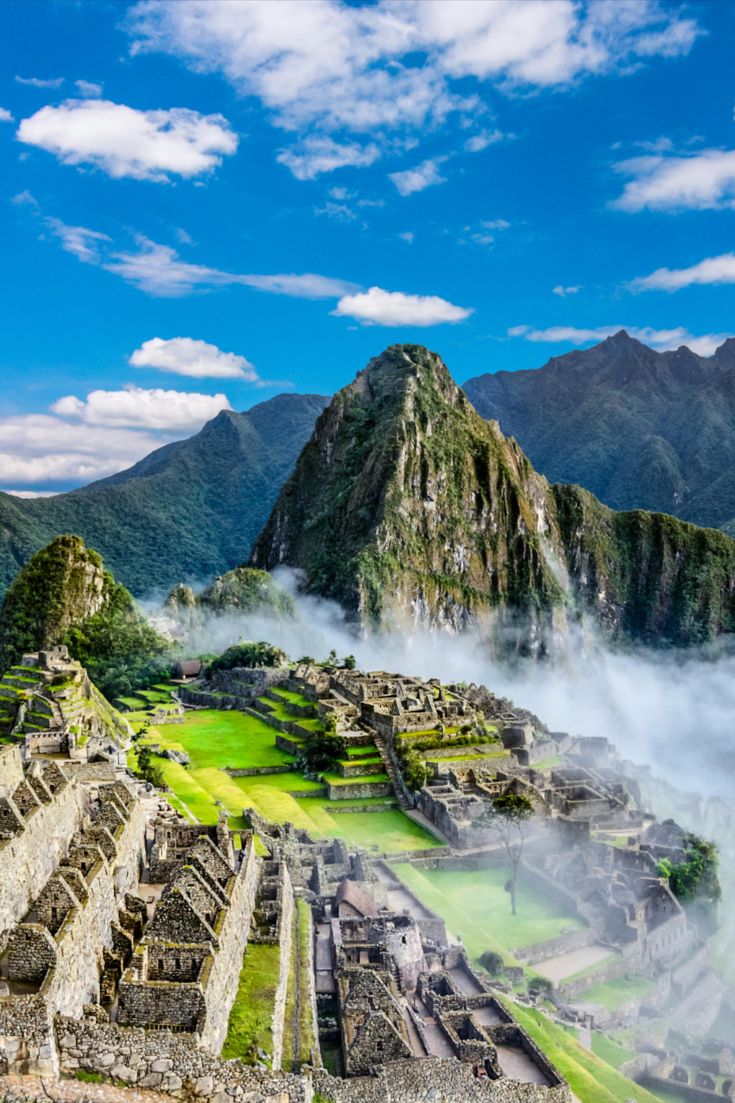 an aerial view of the ancient city of machaca picach in peru, with mountains and clouds