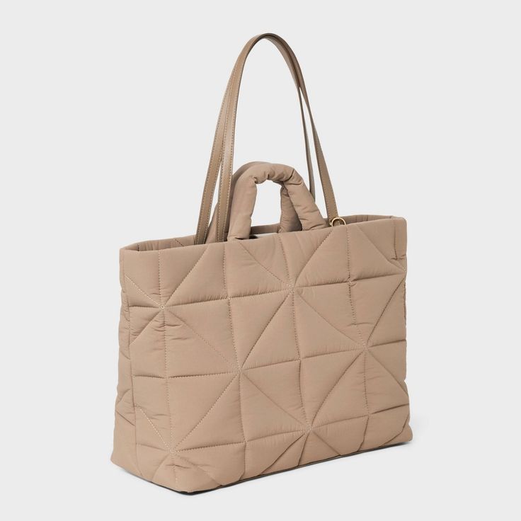 This Kate Tote Handbag from A New Day™ in a solid color showcases an unstructured silhouette with a geometric quilted finish for a chic, textured look and it goes well with any of your outfits. The interior accessories pocket, zip pocket and exterior side pockets help keep your belongings organized. Designed with a magnetic closure, this stylish tote handbag is easy to carry with double shoulder and grab handles. A New Day™: Style that goes wherever you do. Quilted Double Handle Bag, Versatile Quilted Tote Bag, Textured Rectangular Travel Bag, Textured Tote Shoulder Bag For Travel, Textured Travel Tote Shoulder Bag, Chic Textured Travel Bag, Modern Quilted Shoulder Bag For Everyday, Modern Quilted Everyday Shoulder Bag, Everyday Textured Tote Bag