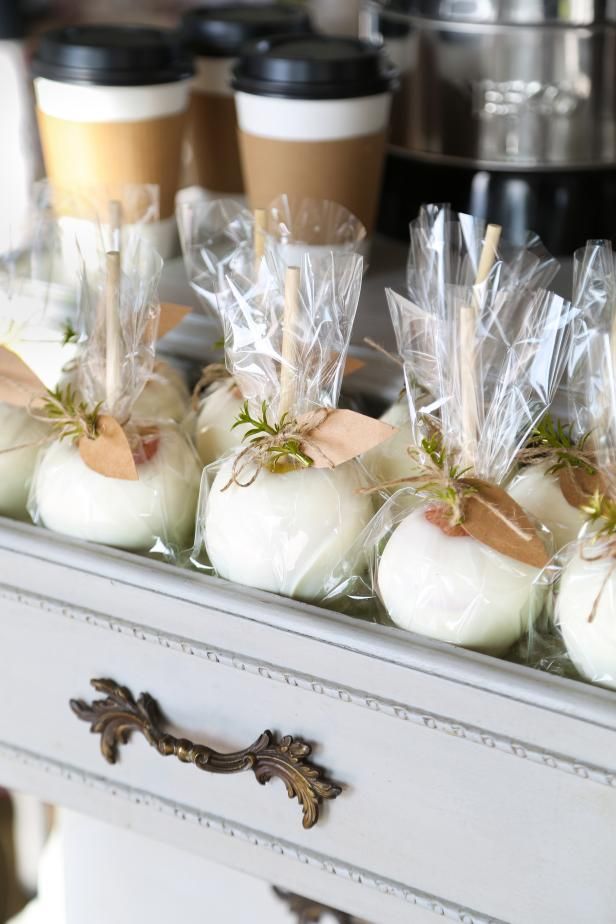 white pumpkins wrapped in cellophane and tied with twine, sitting on an old dresser