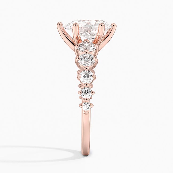 Pear Shaped Echo Diamond Engagement Ring - 14K Rose Gold. Five graduated round diamonds rest on either side of this unique setting, creating a glamorous mirrored look that's modern yet timeless. 
 
 The Reflections Collection, a line of exclusive Brilliant Earth designs, features dynamic jewelry united by motifs that reflect the symmetry of mirroring images found in nature. Luxury Rose Gold Round Wedding Ring, Rose Gold Round Cut Diamond Ring With Center Stone, Exquisite Rose Gold Diamond Ring With Vvs Clarity, Rose Gold Diamond Ring With Diamond Accents, Round Cut, Rose Gold Diamond Ring With Round Cut Accents, Rose Gold Diamond Ring With Center Stone, Dazzling Rose Gold Round Cut Ring, Elegant Rose Gold Round Diamond Ring, Elegant 14k Rose Gold Diamond Ring