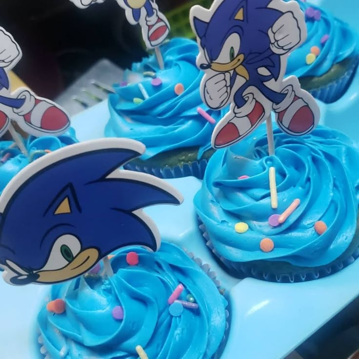 cupcakes with blue frosting and sonic the hedgehog decorations