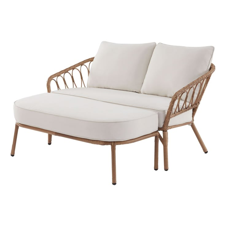 an outdoor chaise lounge chair with white cushions and wicker frame, viewed from the front