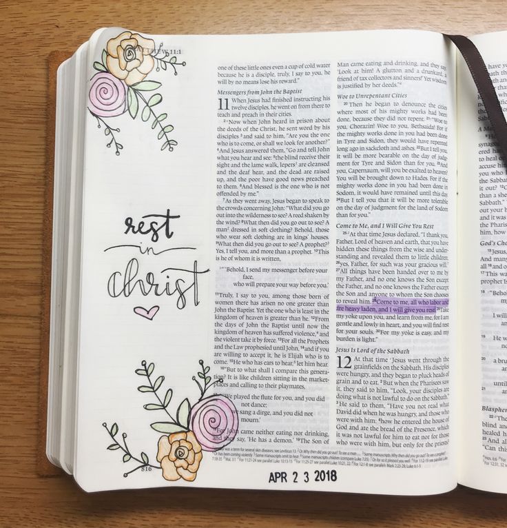 an open bible with flowers on it