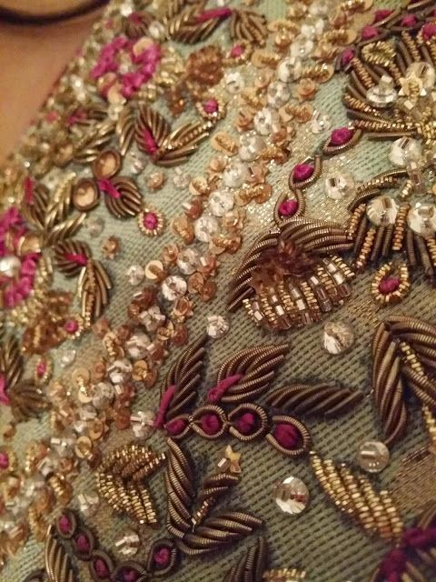 a close up view of the back of a dress with beading and sequins