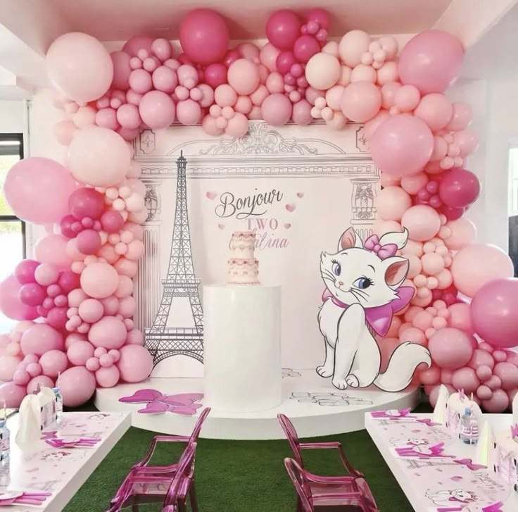 a room filled with tables covered in pink and white balloons, chairs and tablecloths