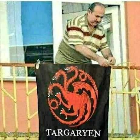 there is a man that is standing next to a sign with a dragon on it