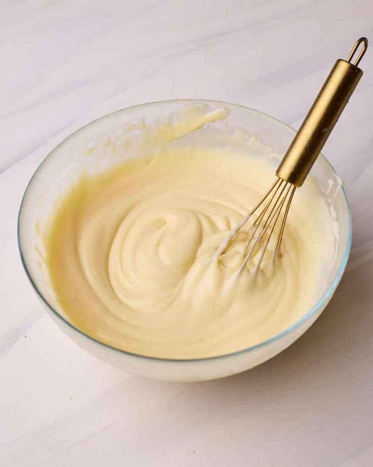 a whisk in a bowl filled with batter