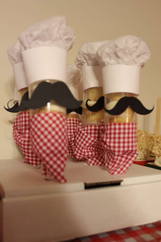 three chefs hats and mustaches on top of each other in front of a table