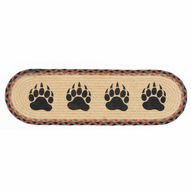 a rug with three paws on it, and four smaller paws in the bottom right corner