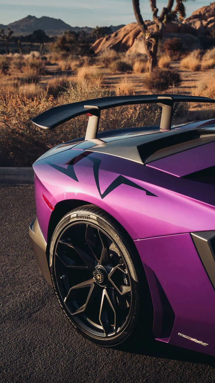 a purple sports car is parked in the desert