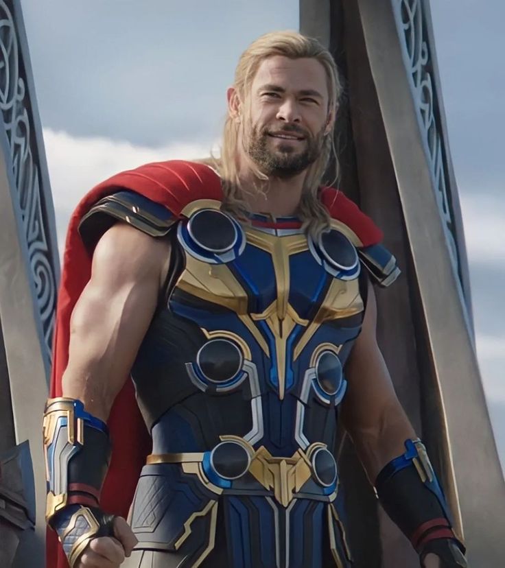 a man dressed as thor is standing in front of some pillars with his hands on his hips