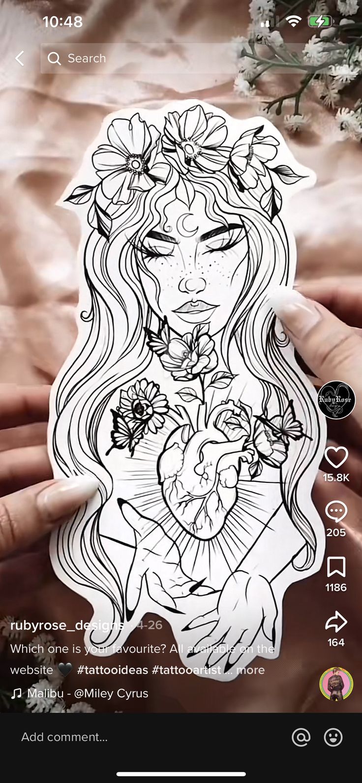 a person holding a sticker with flowers on it